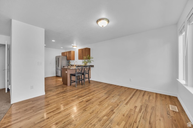 2948 W 150 N, Layton, UT 84041 - living room featuring light wood-style flooring, baseboards, and recessed lighting
