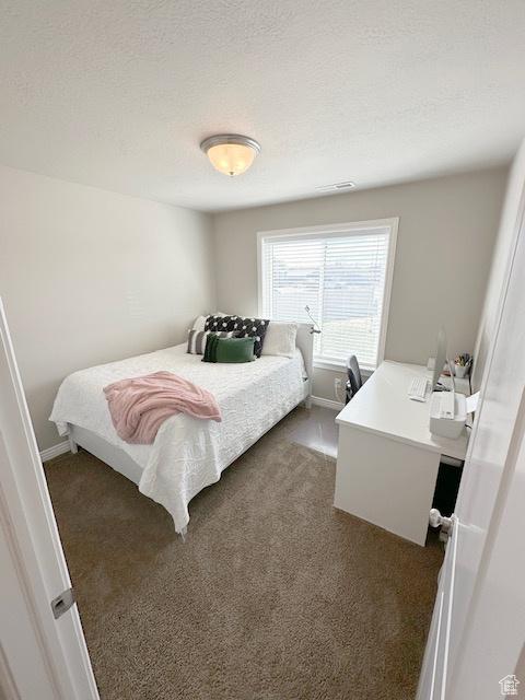 515 S Stump Hollow Rd, Garden City, UT 84028 - bedroom featuring dark carpet and baseboards
