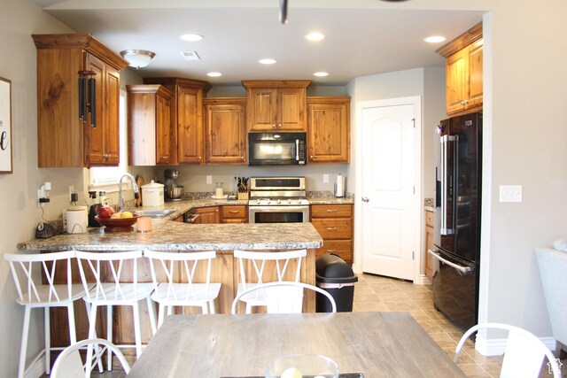 515 S Stump Hollow Rd, Garden City, UT 84028 - kitchen with black microwave, stainless steel range, high quality fridge, a sink, and a peninsula
