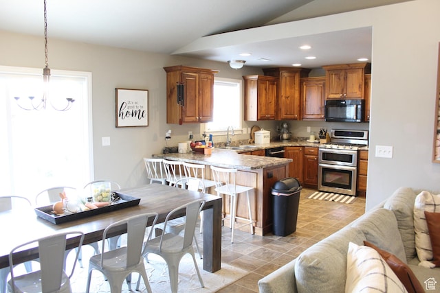 515 S Stump Hollow Rd, Garden City, UT 84028 - kitchen with black microwave, range with two ovens, lofted ceiling, a peninsula, and a sink