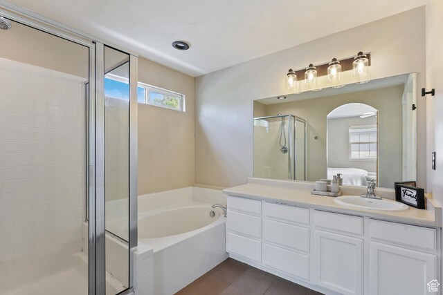 6785 W Callery Ln S, West Jordan, UT 84081 - ensuite bathroom with vanity, a garden tub, wood finished floors, ensuite bathroom, and a shower stall