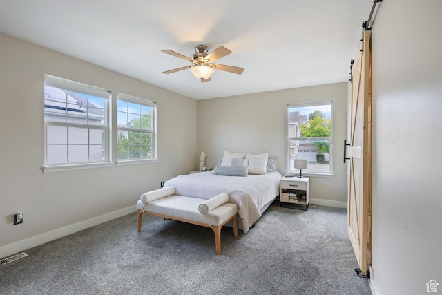 6785 W Callery Ln S, West Jordan, UT 84081 - carpeted bedroom with baseboards, a ceiling fan, a barn door, and visible vents