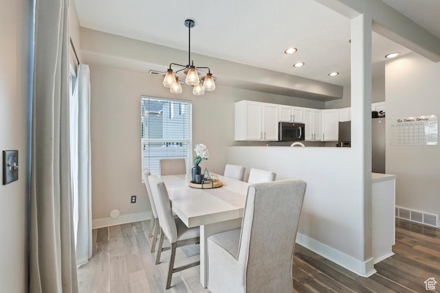 6785 W Callery Ln S, West Jordan, UT 84081 - dining area featuring an inviting chandelier, baseboards, recessed lighting, and wood finished floors