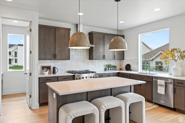242 W Hillcrest Dr Unit 6, Spanish Fork, UT 84660 - kitchen featuring dark brown cabinets, light wood-style floors, range, tasteful backsplash, and stainless steel dishwasher