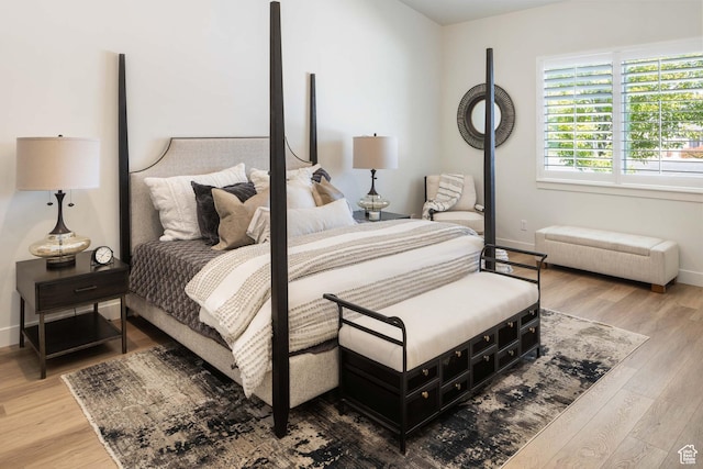 bedroom with baseboards and wood finished floors