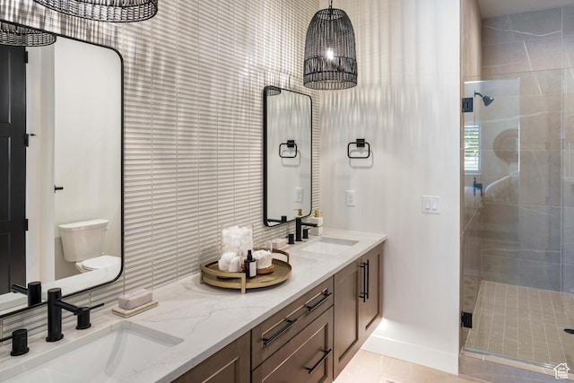 bathroom featuring a sink, a shower stall, and double vanity