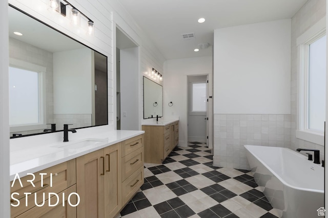 5220 W 2040 S, Hurricane, UT 84737 - full bath featuring plenty of natural light, a soaking tub, tile walls, two vanities, and tile patterned floors