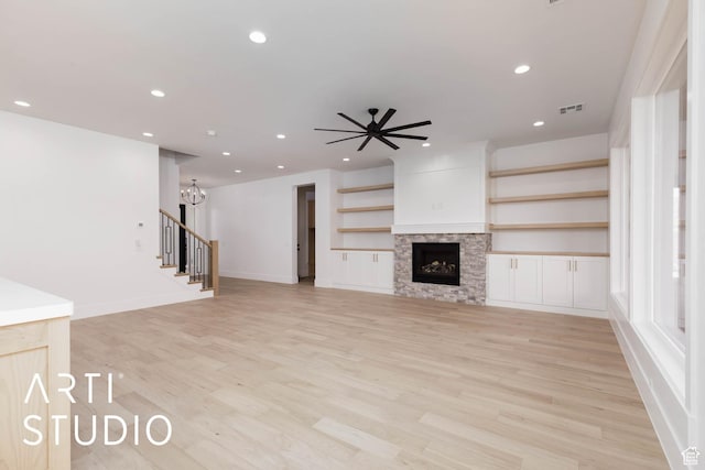 5220 W 2040 S, Hurricane, UT 84737 - unfurnished living room with recessed lighting, light wood finished floors, a fireplace, a chandelier, and a ceiling fan