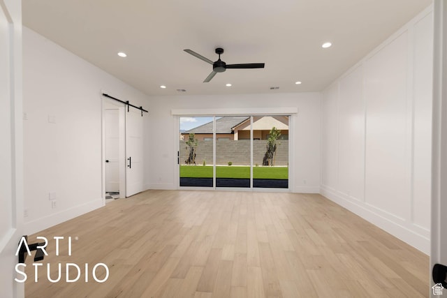 5220 W 2040 S, Hurricane, UT 84737 - unfurnished bedroom featuring a barn door, access to outside, light wood-type flooring, recessed lighting, and baseboards