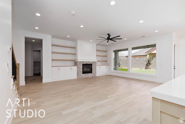5220 W 2040 S, Hurricane, UT 84737 - unfurnished living room featuring light wood-style floors, a ceiling fan, recessed lighting, a glass covered fireplace, and baseboards