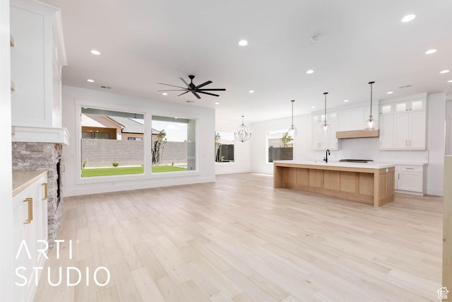5220 W 2040 S, Hurricane, UT 84737 - kitchen with open floor plan, a sink, decorative backsplash, recessed lighting, and light countertops