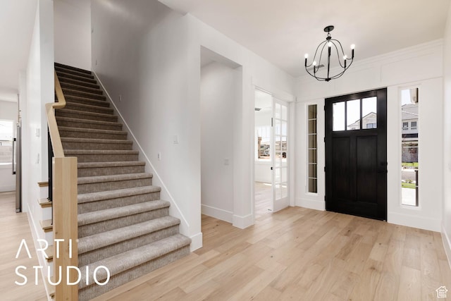 5220 W 2040 S, Hurricane, UT 84737 - entryway with light wood finished floors, stairs, a chandelier, and baseboards