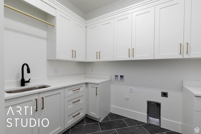 5220 W 2040 S, Hurricane, UT 84737 - laundry area with cabinet space, dark tile patterned floors, electric dryer hookup, hookup for a washing machine, and hookup for a gas dryer