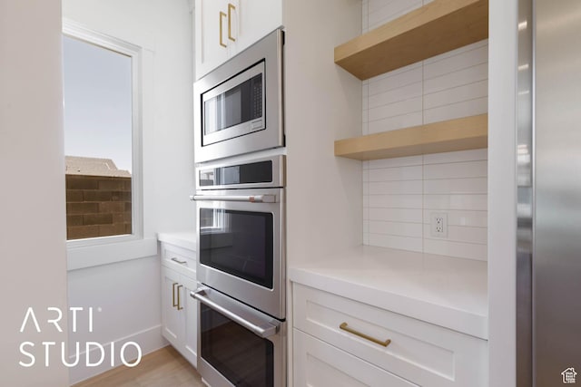 5220 W 2040 S, Hurricane, UT 84737 - kitchen featuring stainless steel appliances, decorative backsplash, light countertops, white cabinets, and open shelves