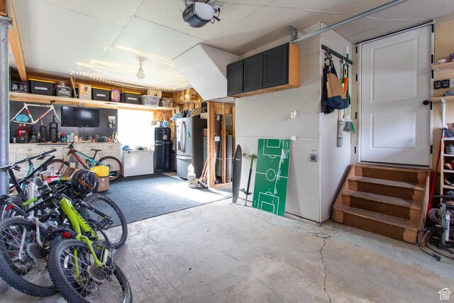 465 S Main St, Providence, UT 84332 - garage featuring a garage door opener and freestanding refrigerator