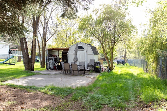 465 S Main St, Providence, UT 84332 - view of yard featuring an outdoor structure, a patio area, fence, and a storage unit