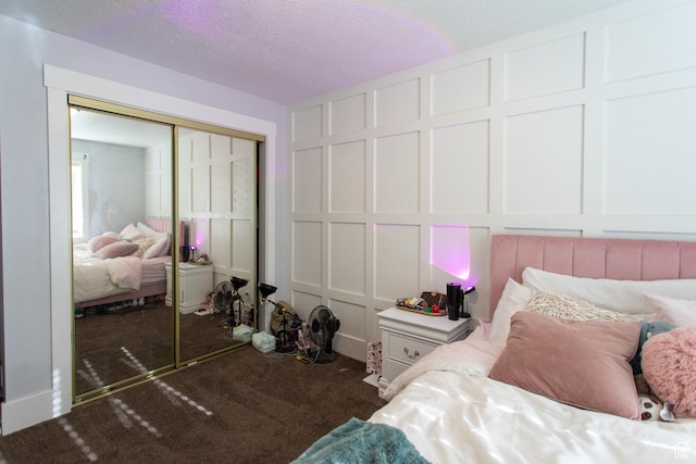 465 S Main St, Providence, UT 84332 - bedroom with a closet, a decorative wall, carpet flooring, and a textured ceiling