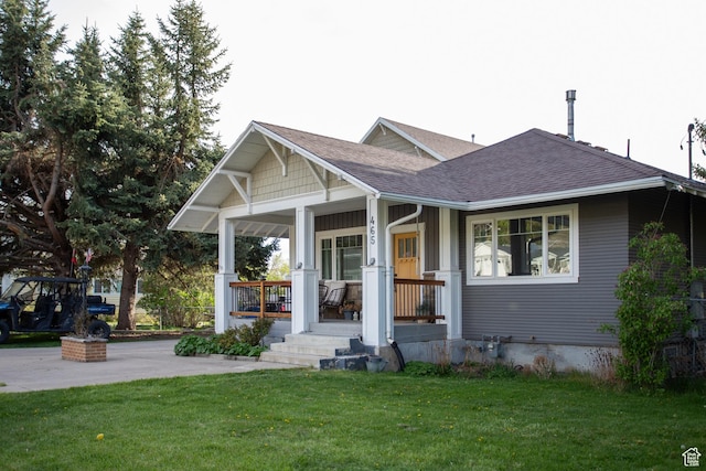 465 S Main St, Providence, UT 84332 - view of front of home featuring a shingled roof, a front lawn, and covered porch
