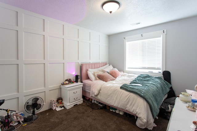 465 S Main St, Providence, UT 84332 - bedroom featuring dark colored carpet, a textured ceiling, and visible vents