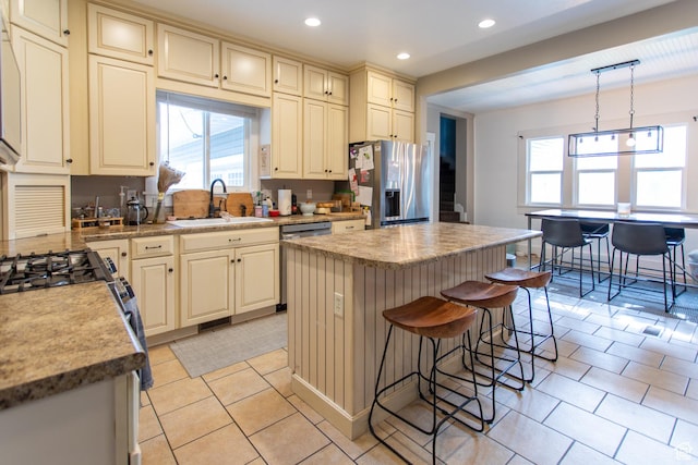 465 S Main St, Providence, UT 84332 - kitchen featuring recessed lighting, cream cabinets, a sink, appliances with stainless steel finishes, and light tile patterned floors
