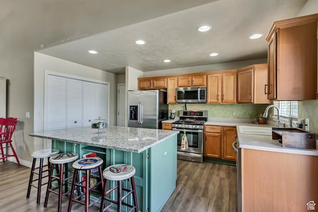 126 W Casi Way, Saratoga Springs, UT 84045 - kitchen featuring stainless steel appliances, a sink, dark wood-style floors, a center island, and recessed lighting