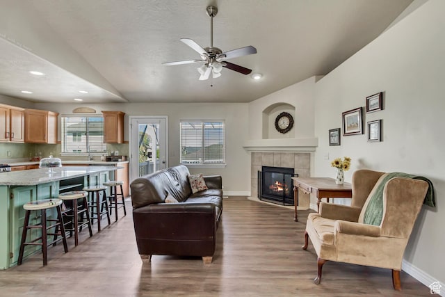 126 W Casi Way, Saratoga Springs, UT 84045 - living area with vaulted ceiling, baseboards, a fireplace, light wood-type flooring, and ceiling fan