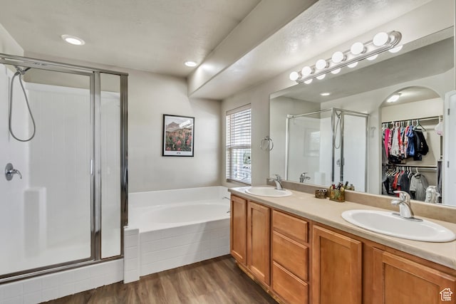 126 W Casi Way, Saratoga Springs, UT 84045 - bathroom featuring a stall shower, a bath, a spacious closet, double vanity, and wood finished floors