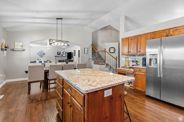 2582 W 1890 N, Clinton, UT 84015 - kitchen featuring lofted ceiling, a kitchen island, dark wood-style floors, stainless steel fridge with ice dispenser, and arched walkways