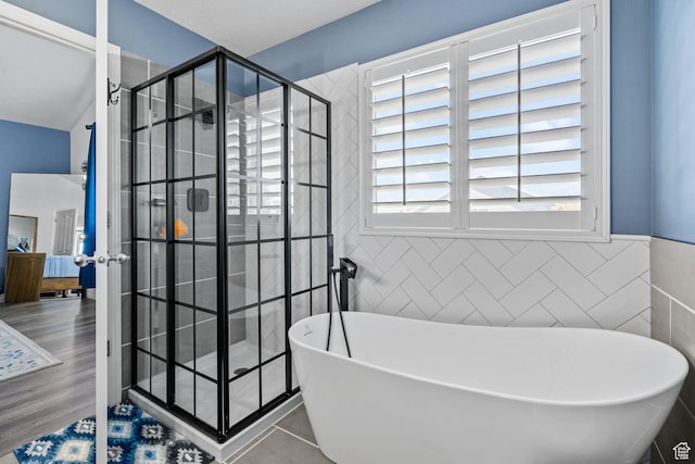 2582 W 1890 N, Clinton, UT 84015 - full bathroom with wainscoting, a shower stall, a soaking tub, and tile walls