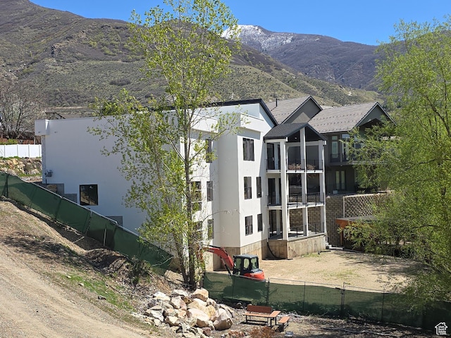 1480 E Belle Ct, Fruit Heights, UT 84037 - view of home's exterior featuring fence, a mountain view, and stucco siding