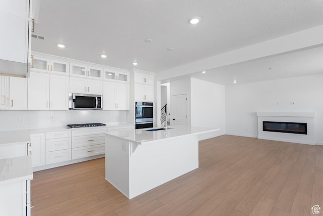 894 S 1100 W, American Fork, UT 84003 - kitchen with stainless steel microwave, white cabinetry, visible vents, and light wood-style floors