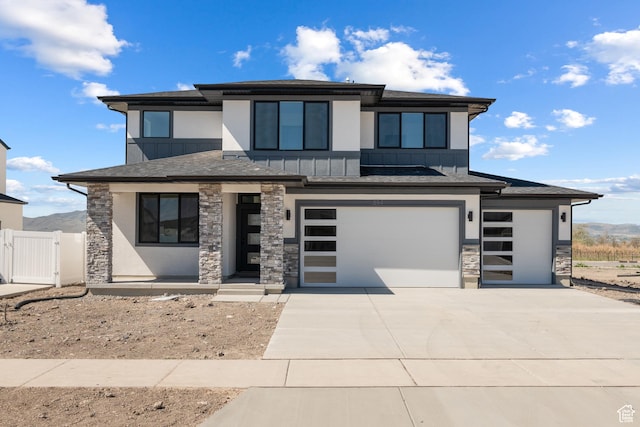 894 S 1100 W, American Fork, UT 84003 - prairie-style house with stone siding, an attached garage, a gate, board and batten siding, and driveway