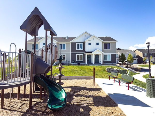 community playground with a lawn, fence, and a residential view