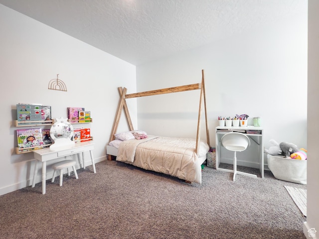 bedroom featuring baseboards, carpet flooring, and a textured ceiling