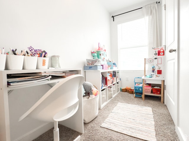 rec room with carpet flooring and baseboards