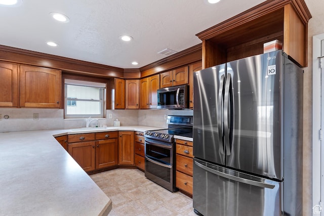 731 W 3750 N, Pleasant View, UT 84414 - kitchen featuring light countertops, brown cabinets, tasteful backsplash, a sink, and stainless steel appliances