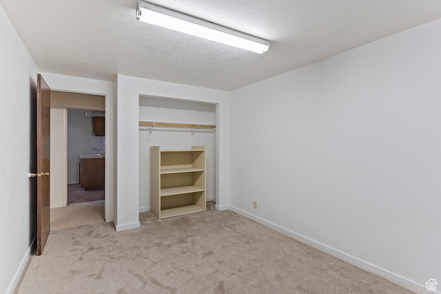 731 W 3750 N, Pleasant View, UT 84414 - unfurnished bedroom featuring carpet floors, a textured ceiling, baseboards, and a closet
