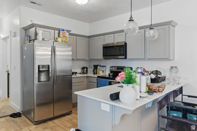 3647 W 1530 N Unit Hh204, Lehi, UT 84043 - kitchen with appliances with stainless steel finishes, visible vents, light wood-style floors, a peninsula, and gray cabinetry