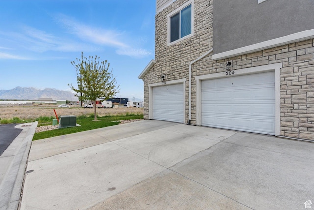 garage featuring a mountain view and concrete driveway