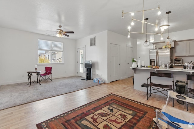 3647 W 1530 N Unit Hh204, Lehi, UT 84043 - living area with light wood-style floors, baseboards, ceiling fan, and visible vents