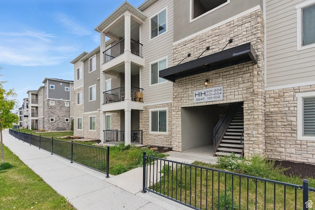 3647 W 1530 N Unit Hh204, Lehi, UT 84043 - view of property with a residential view, fence, and stairway
