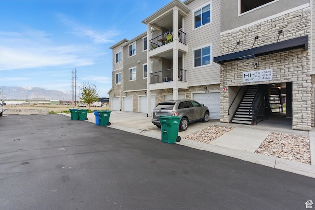 3647 W 1530 N Unit Hh204, Lehi, UT 84043 - view of building exterior with an attached garage, a mountain view, and driveway