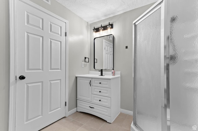3559 W Lexington View Dr, West Jordan, UT 84088 - bathroom featuring a textured ceiling, a shower stall, vanity, baseboards, and tile patterned floors