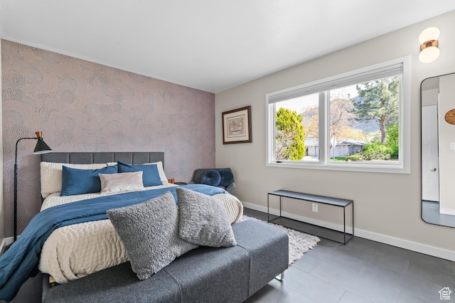 tiled bedroom featuring baseboards, an accent wall, and wallpapered walls