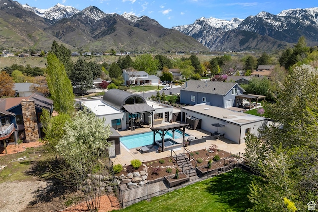 exterior space featuring a fenced backyard, a mountain view, a patio area, and a residential view