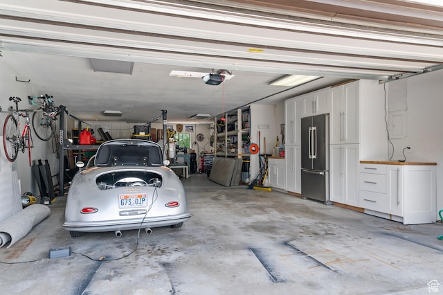 garage with a garage door opener and high end fridge