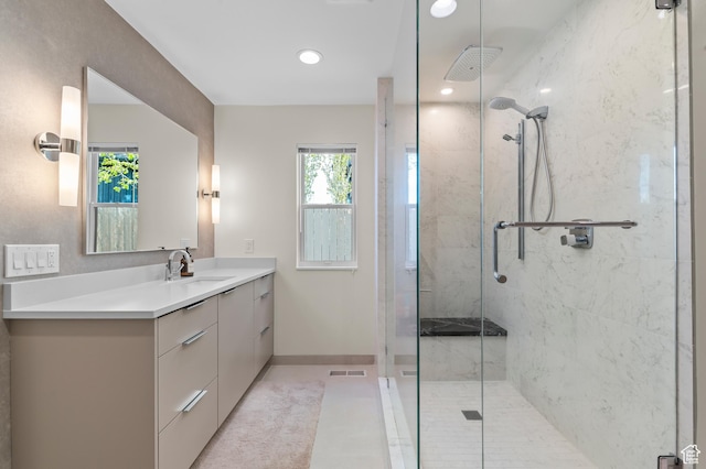 bathroom featuring baseboards, a stall shower, visible vents, and vanity