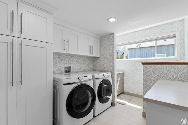 laundry room featuring cabinet space, independent washer and dryer, wallpapered walls, and recessed lighting