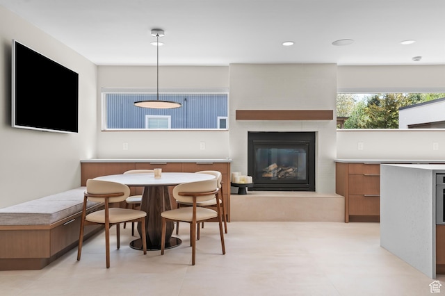 dining space with recessed lighting and a fireplace