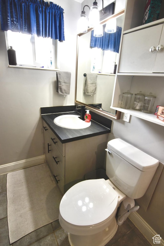 3223 S Fairlane St, Magna, UT 84044 - bathroom featuring baseboards, toilet, and vanity